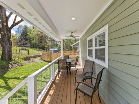 Comfortable outdoor seating on the back porch invites you to sit down, relax, and enjoy watching the birds and wildlife.