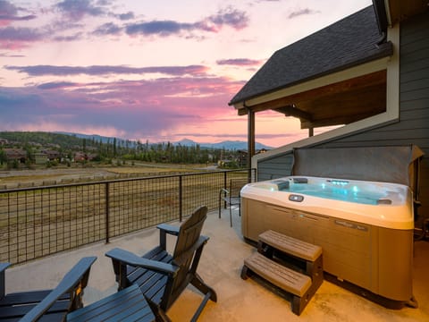Soak away stress in the bubbling hot tub with breathtaking open sky mountain views - Elevated privacy wall and covered roof make it usable in any season or weather - Perfect for unwinding after hikes, slopes, or simply a relaxing day in nature