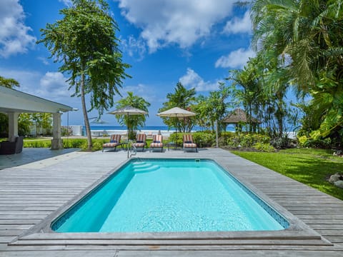 The stunning pool deck complete with loungers and umbrellas