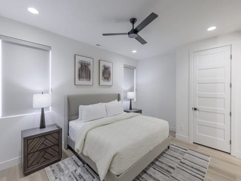 The main bedroom is furnished with a King bed, private TV, and walk-in closet.