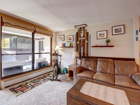 Living area with large windows and enclosed porch.