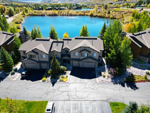 Aerial view of the townhome with a pond in the background.