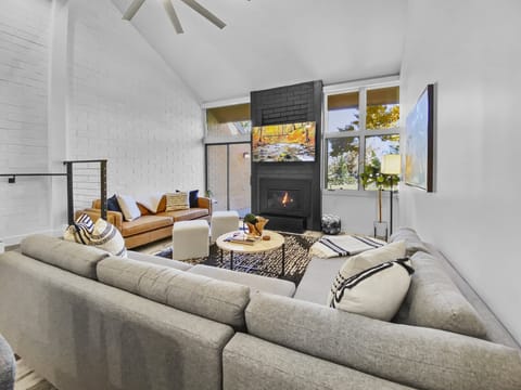 Cozy Living Room with Fireplace and Big Screen TV