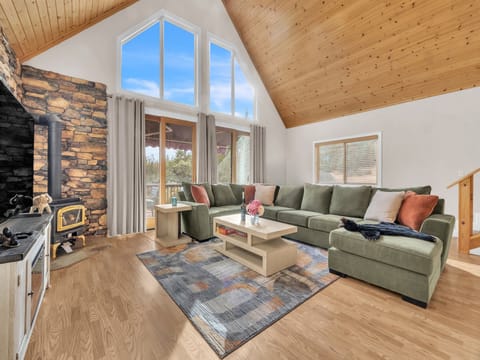 Living Room area showing gas stove for chilly winter months and oversized sliders that lets in lots of natural sunlight