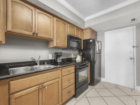 Upon entry, you arrive to the fully stocked kitchen that offers both small and large appliances. Granite countertops and loaded cabinetry is featured in this great space.