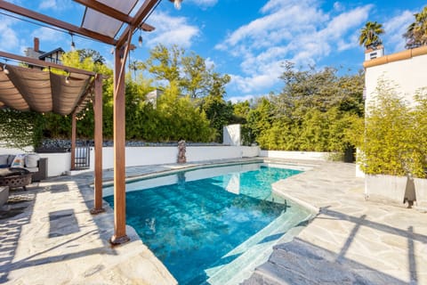 Private backyard pool with lush landscaping.