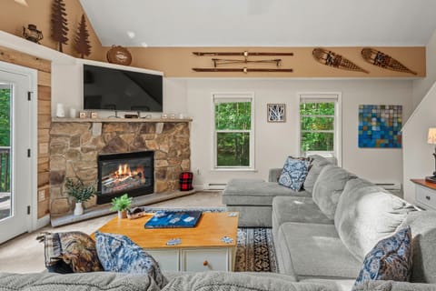 This cozy living room exudes warmth and comfort, perfect for relaxing by the fireplace.