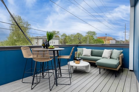 Private balcony with an al fresco dining area and comfortable lounge seating.