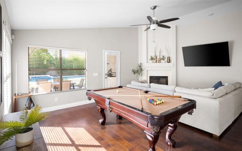 Our pool table is in the living room - surrounded by the couch, TV, and access to the outside pool area!
