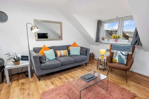 Living area with ample natural lighting and comfortable seating