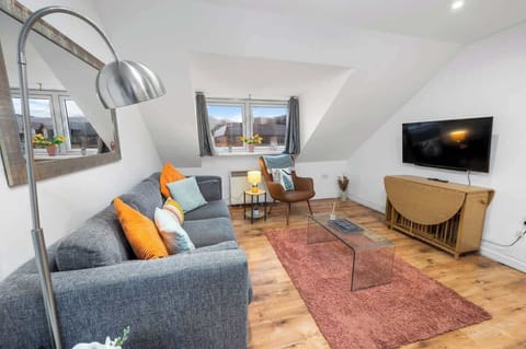 Living area with ample natural lighting and comfortable seating