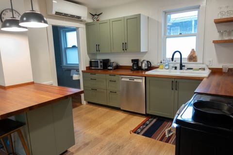 Large eat in kitchen with island, fully stocked with new appliances.