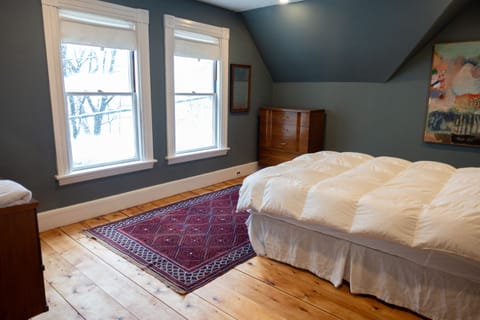 Upstairs primary bedroom with queen bed and mountain views.