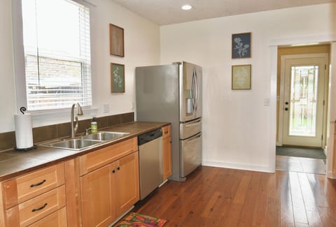 Large Kitchen leads to Laundry room with back door to Deck & Fire pit. 