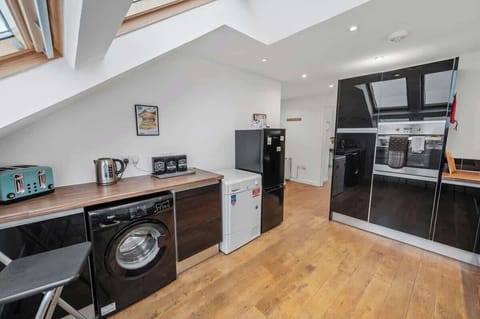 Modern kitchen stocked with everything needed to enjoy a home-cooked meal and a washing machine