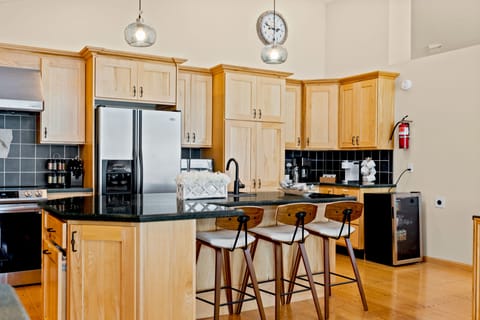 This kitchen has a coffee/tea bar and a beverage cooler. 