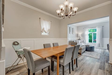 Beautiful Lighting Streaming Through the Expansive Window, Connecting the Dining Space with the Charming Living Room
