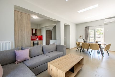 Our living space, furnished with a plush sofa, dining table, well-appointed kitchen, and a balcony, ensuring a bright and inviting retreat.