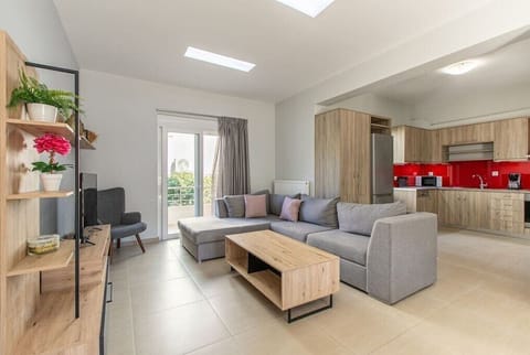 Our living space, furnished with a plush sofa, an armchair, and a well-appointed kitchen, and a balcony, ensuring a bright and inviting retreat.