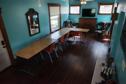 The main living space in the downstairs can be set up to feature a living room with a couch, two arm chairs and dinner table (as pictured in the next pic) or above. The space can fit up to 15 adults for a small dinner party / gathering space.