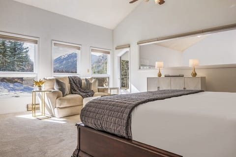 Spacious master bedroom with king size bed and picture windows looking at Maroon Bells