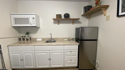 Fridge, microwave, coffee/tea maker, cookware/dishes/utensils