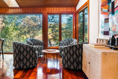 Sip, chat, and unwind in our inviting living space surrounded by soothing green vistas."