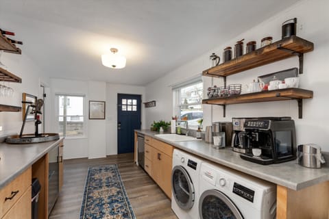 You will enter through our Welcome Room equipped with Coffee Bar, Wine Bar and beverage fridge. Small laundry to the right.