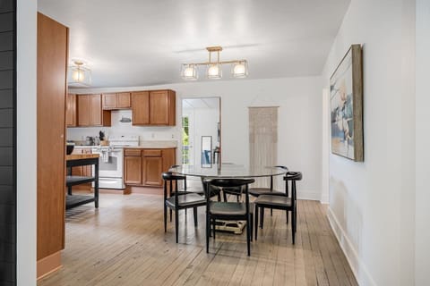 Standing in living room and looking into the kitchen and dining area; can look further into office area and back door leading to the sun deck