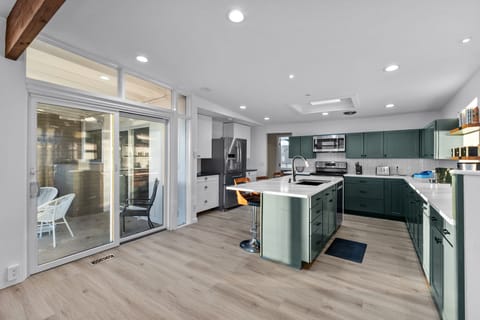 Fully stocked kitchen and access to the covered back patio and grill