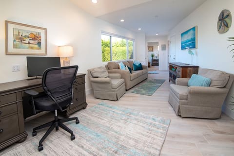 This spacious den is off the kitchen. It is a great place to hang out or work.