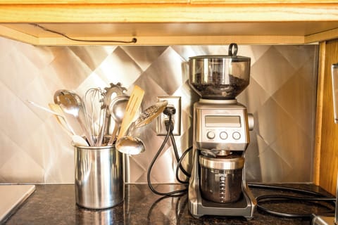 The Breville burr grinder is stocked with organic coffee beans, ready to grind.