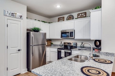 A well-equipped kitchen with modern appliances, ample countertop space, and a built-in heater—perfect for cooking meals in comfort year-round.