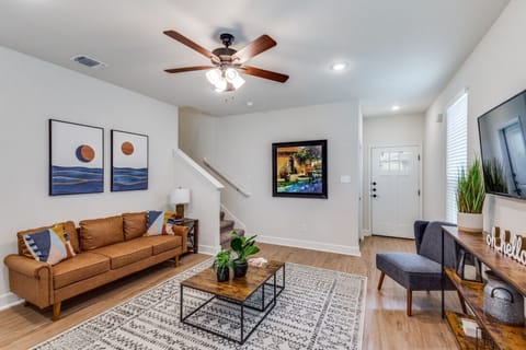 A bright and inviting living room with a comfy sofa, smart TV, and stylish decor—perfect for unwinding or entertaining guests.