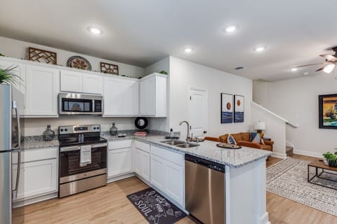 A well-equipped kitchen with modern appliances, ample countertop space, and a built-in heater—perfect for cooking meals in comfort year-round.