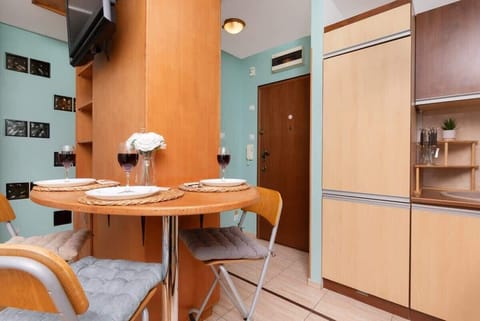 Another perspective of the open-plan kitchen, emphasizing the warm wooden tones, mint-green accent walls, and ample cabinetry.


