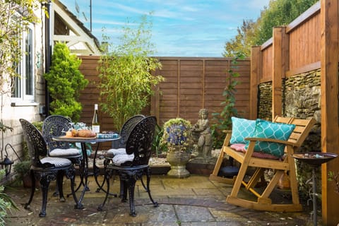 Enclosed courtyard garden with garden furniture and a rocking bench