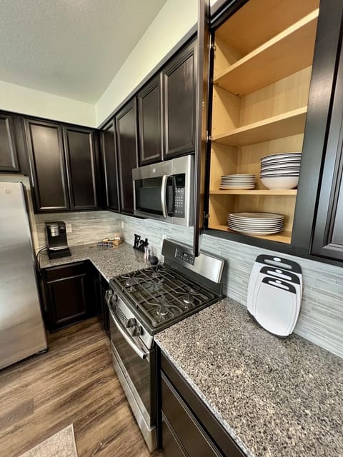 Kitchen is fully stocked with dishes, cups, etc + stainless steel appliances