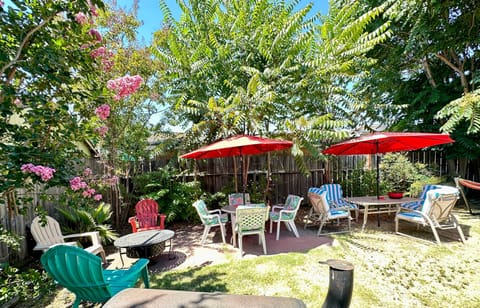 Private-backyard-patio-outdoor-seating-barbecue pit-umbrellas-garden-lounge-area