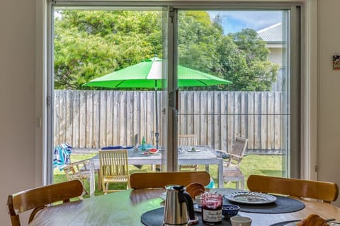 Sliding doors lead out from the kitchen and dining area to the backyard.