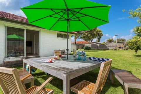 The fully-fenced backyard offers ample seating for the group to enjoy meals alfresco, with an umbrella to provide some shade in the summer sun.