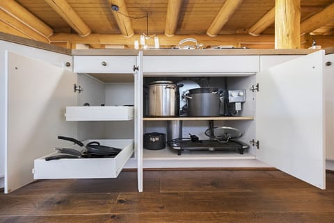 Fully stocked kitchen cabinets with cookware and essentials