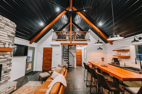 A view of the bunk loft, overlooking the kitchen and living room, and on out over the meadow.