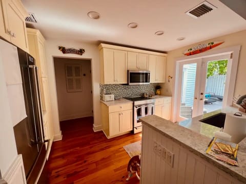 Well-equipped kitchen featuring a microwave and induction stove.