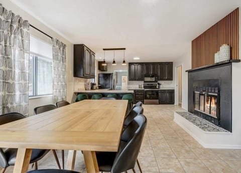 Choose to dine in the cozy dining room or cook in the kitchen, both enhanced by the warmth of the indoor fireplace. It's the perfect combination for a delightful and inviting culinary experience at Evergreen Luxe.