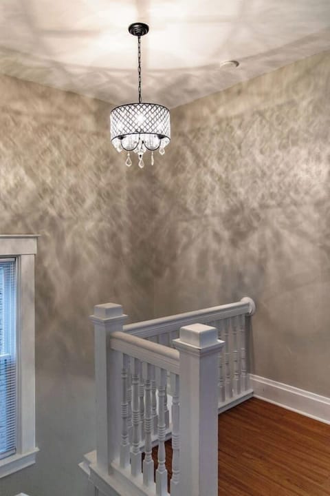 Elegant chandelier, adding a touch of sophistication and charm to the room, creating a warm and inviting ambiance.