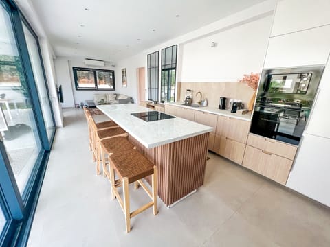 Spacious kitchen with island connected to entertainment areas
