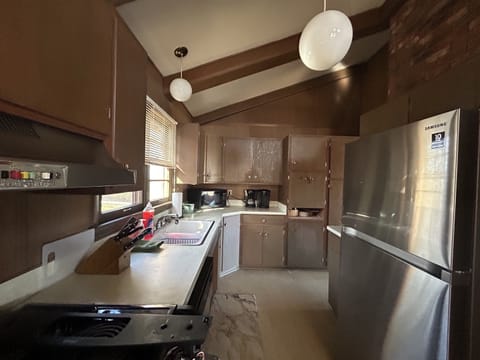 Galley style kitchen. Well stocked for cooking needs.