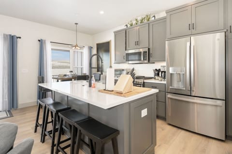 Culinary bliss awaits in our open kitchen with quartz countertops and state-of-the-art appliances.