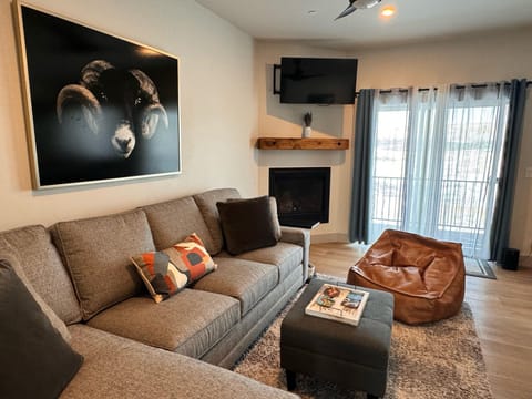 Relax by the fireplace in a living room that radiates warmth and style.